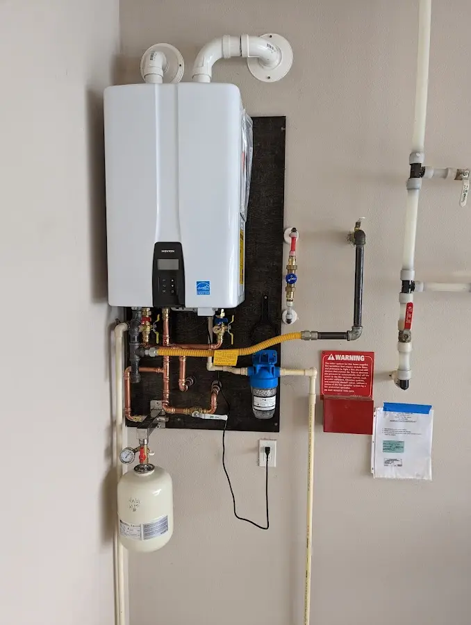 Professional plumber installing copper piping in a Whiskey Creek home